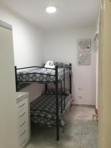 A bed or beds in a room at Billy's Las Rocas Apt Playa de Mogan with pool access