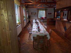 a long dining room with a long table with chairs at Waldhaus Crottendorf in Crottendorf