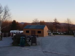a building with a picnic table in a parking lot at Wyreside Lakes Glamping Pods in Lancaster +7 photos