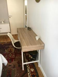 a wooden table and a chair in a room at Farsta Bed and Breakfast in Stockholm