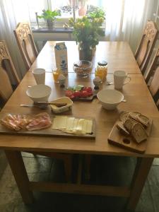a wooden table with food on top of it at Farsta Bed and Breakfast in Stockholm