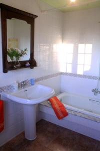 a bathroom with a sink and a bath tub at Casa rural agro da moa in As Mirans