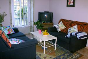 a living room with two couches and a table at Casa rural agro da moa in As Mirans