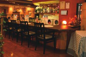 a bar in a restaurant with chairs and a counter at Smile Hotel Sendai-Kokubuncho in Sendai