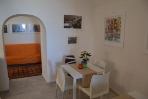 a room with a table and chairs and a bedroom at Terra Murata Boutique b&b in Procida