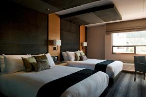 Voodi või voodid majutusasutuse Ramada Plaza by Wyndham Prince George toas