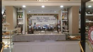 a counter in a restaurant with a display window at Spazio Cavour Guesthouse in Rome