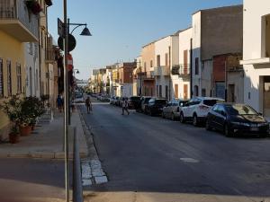 a street with cars parked on the side of the road at Bilocale Mini Very in San Vito lo Capo