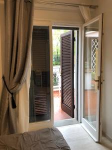 a bedroom with a sliding glass door to a patio at Il portico B&b in Faenza