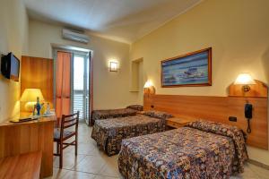 a hotel room with two beds and a desk at Hotel Eden in Turin +104 photos