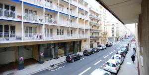 a city street with cars parked in front of buildings at Appart' Maréchal in Lyon