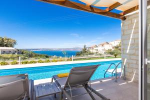 a view from the balcony of a villa with a swimming pool at Sun and Sea Plus Resort in Plaka