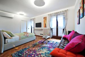 a living room with a couch and a rug at B&BLaTosca in Marina di Massa