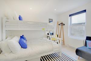 a white bunk bed in a white room with a window at Brighton's Best BIG House - Sleeps 12 to 18 guests - 4 bedrooms in Brighton & Hove