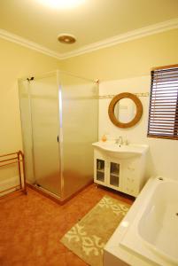 a bathroom with a shower and a sink at Mountain Park Retreat in Perth