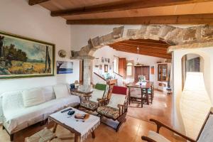 a living room with a couch and a table at Villa Son Fullos in Santa Margalida