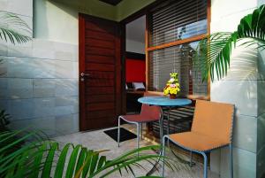 a small table and two chairs on a porch at Taman Ayu Town House in Denpasar