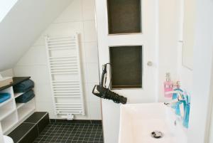 a small bathroom with a sink and a mirror at Deichhotel Rose in Juist +37 photos