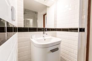 
a white toilet sitting next to a sink in a bathroom at Pension Dientzenhofer in Prague
