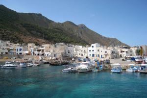 a group of boats docked in a harbor with buildings at Casa Elena in Trapani