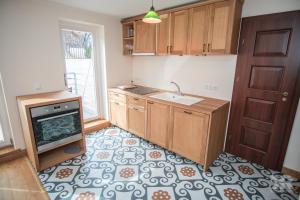 a kitchen with a sink and a stove at Maria 4 Apartment in Tartu