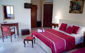 a bedroom with a large bed and a table and chair at B&B MareAgrò in Santa Teresa di Riva