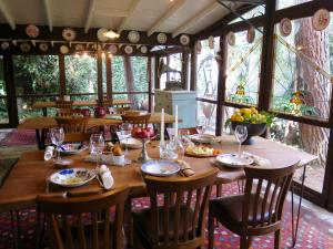 a dining room with a wooden table and chairs at Hotel Kalehan in Selçuk