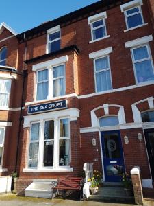 a red brick building with a sign that reads the sea croft at The Sea Croft Bed Breakfast & Bar in Lytham St Annes