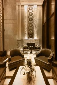 a lobby with couches and a table and a wine cellar at Paramount Gallery Hotel in Shanghai