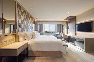 a hotel room with a large bed and a desk at El Embajador, a Royal Hideaway Hotel in Santo Domingo