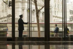 a man standing in front of a window with a train at Four Seasons Hotel San Francisco in San Francisco