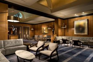 a lobby with couches and tables and chairs at Four Seasons Hotel San Francisco in San Francisco