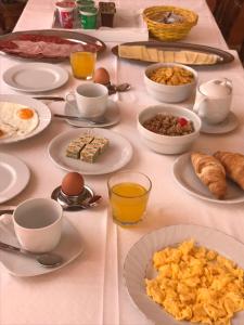 a table with plates of breakfast food on it at Guest House Sandra in Rab