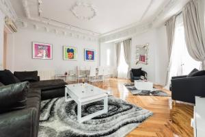 a living room with a couch and a table at M&F ATTIC WITH GREAT VIEWS in Madrid