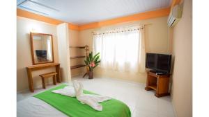 a room with a towel rabbit sitting on a bed at Cabañas Yakuruna in Leticia