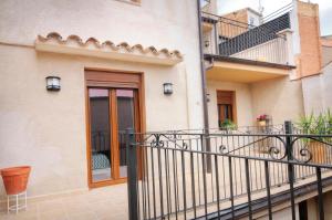 a balcony of a building with a door at Cal Blai in Mora la Nueva