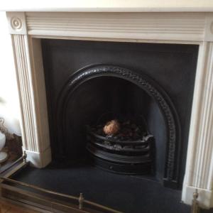 a fireplace with a black fire place in a room at Cheltenham Lawn and Pittvile Gallery in Cheltenham