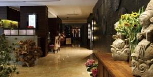 a lobby with vases of flowers on a counter at SSAW Boutique Hotel Hangzhou Yilian in Hangzhou