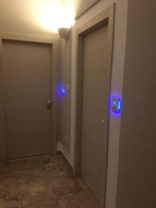 two doors with blue lights in a hallway at Residence Ducale in Rodi Garganico