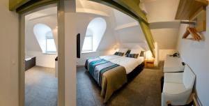 Säng eller sängar i ett rum på Villa Valkenburg