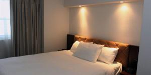 Ένα ή περισσότερα κρεβάτια σε δωμάτιο στο Hotel Classique