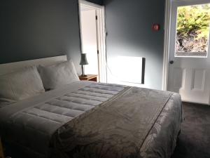 a bedroom with a large bed and a window at Driftwood Villa in Kaikoura