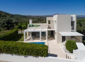 a large white house with a swimming pool at Villa Gonia in Gonia