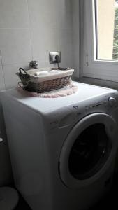 a washing machine with a basket on top of it at Gardens House in Varenna