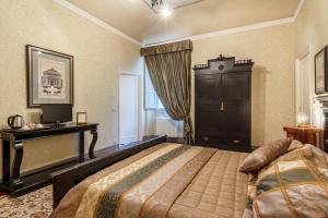 Säng eller sängar i ett rum på Locanda San Marco Residenza Caluri