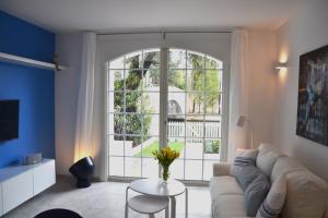 a living room with a couch and a large window at Maison d'Azur in Grimaud