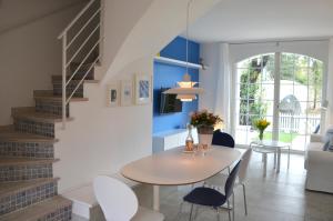 a dining room and living room with a table and chairs at Maison d'Azur in Grimaud