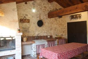 a kitchen with a table and a sink and a stove at Cotanilla in Cubillo