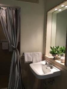 a bathroom with a sink and a mirror at La casa dell'Arte nel cuore di Roma in Rome