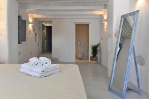 a room with a mirror and towels on a bed at Sand Key Villa 2 in Santa Maria +37 photos